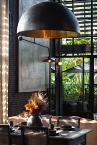 a large lamp over a table in a restaurant at The Bohemian Bali in Canggu