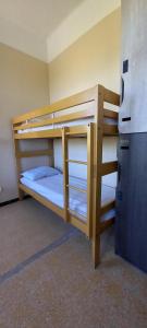 two bunk beds in a room with a refrigerator at Auberge de Jeunesse HI Marseille Bois-Luzy in Marseille