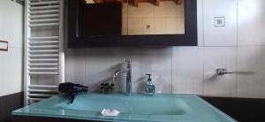 a bathroom with a green sink with a faucet at AgroPhilia in Kourkouloí +17 photos