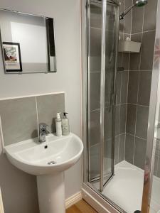 a bathroom with a sink and a shower at Lichfield City Home in Lichfield