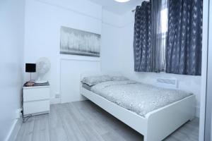 En eller flere senge i et værelse på London Town Apartment- Lewisham