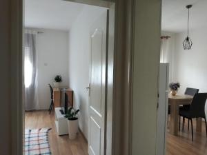 an open door to a living room with a table at Apartman "Milka" Bajina Bašta in Bajina Bašta +12 photos