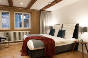 a bedroom with a large bed and two windows at Kulturdenkmal der Gänsbühl auf der Stadtmauer in Gengenbach