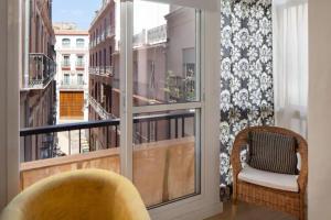 a room with a window with a view of a city at Garcia Briz by Bossh! Apartments in Málaga