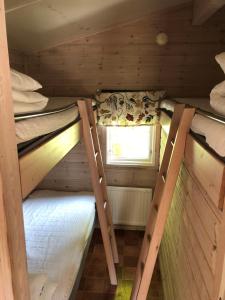 two bunk beds in a small room with a window at Stockholm Swecamp Flottsbro in Huddinge