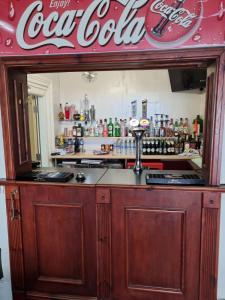a bar with a cocacola sign on top of it at Funky Towers in Blackpool