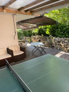a ping pong table and chairs on a patio at WuhrsteinHaus in Schleching