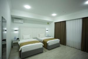 Кровать или кровати в номере Viva Hotel
