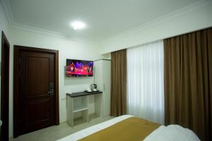 a hotel room with a bed and a television at Viva Hotel in Tashkent +33 photos