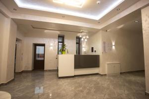 a large lobby with a large television and a large room at Viva Hotel in Tashkent