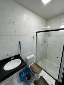 a bathroom with a sink and a toilet and a shower at JH Flats in Maragogi