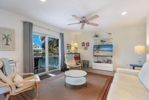 a living room with a couch and a ceiling fan at Coconut Bayou home in Anna Maria