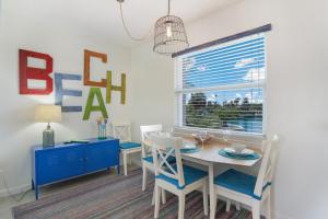a dining room with a table and chairs and a window at Coconut Bayou home in Anna Maria
