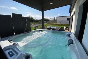 a jacuzzi tub in the backyard of a house at carantec 4 stars villa with jacuzzi and garden for 8 persons in Carantec