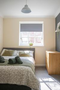a bedroom with a large bed with a window at Lovely 3-bedroom apartment in Colchester in Colchester