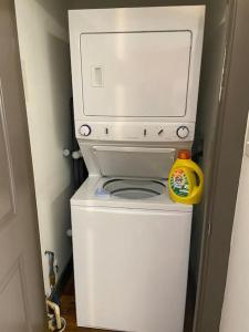 a white microwave sitting on top of a toilet at Charming 2 bedroom apartment near VCU in Richmond