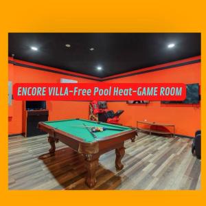 a pool table in a room with an orange wall at 331-Luxury Villa wPOOL & SPA By Disney in Orlando