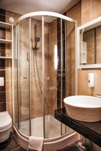 a bathroom with a shower and a sink at Hotel Lent superior in Maribor