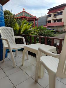 a pair of chairs and a table on a balcony at NB House in Karon Beach