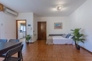 a bedroom with a bed and two potted plants at Pontelagoscuro Huge & Residential Apartment in Ferrara
