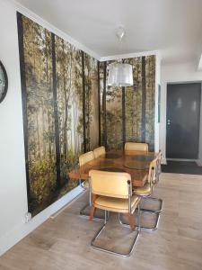 una sala da pranzo con tavolo e sedie in legno di Au 66 Maison centre ville-Parking gratuit et WIFI a Nogent-le-Rotrou