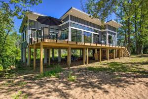 a large house with a deck with an umbrella at Modern Beachfront Oasis in Stockholm with Dock! in Stockholm