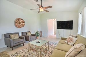 a living room with a couch and a tv at Bermuda Dunes Home with Private Pool and Hot Tub! in Bermuda Dunes