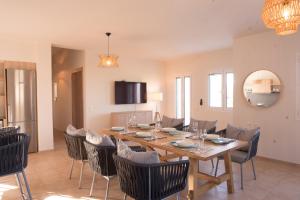 a dining room with a wooden table and chairs at Crete Garden Guesthouse in Agios Nikolaos