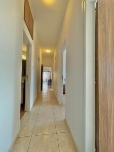 a hallway with white walls and a tile floor at Urban Retreat - Your Ideal Getaway in Limassol in Limassol