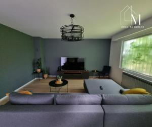 ein Wohnzimmer mit einem lila Sofa und einem TV in der Unterkunft Kuća za odmor Maja in Ðakovo