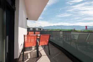 a balcony with chairs and a view of the mountains at Amaria Downtown Aparthotel Villach in Villach