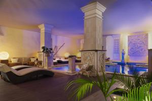 a large living room with a swimming pool and a house at Royal Garden Villas, Luxury Hotel in Adeje