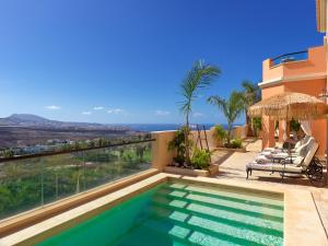 a villa with a swimming pool and a view of the ocean at Royal Garden Villas, Luxury Hotel in Adeje