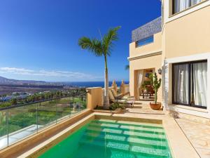 a villa with a swimming pool and a view at Royal Garden Villas, Luxury Hotel in Adeje