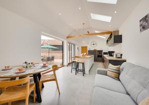 a kitchen and living room with a couch and a table at The Corn Barn in Kersey