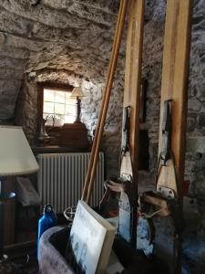 a room with two ski poles and a chair at La Thuillettaz B&B in Saint-Rhémy-en-bosses