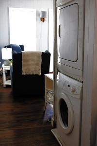 a living room with a washing machine and a tv at Sweet Mary home in Jamestown