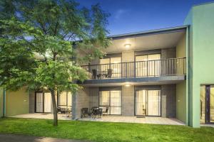 an apartment building with a balcony and a tree at Quest Sale in Sale