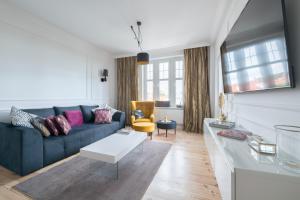 a living room with a couch and a table at Dom & House - Apartment Golden Loft Sopot in Sopot