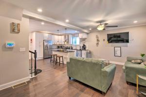 a living room with a couch and a kitchen at Stylish College Park Home with Private Garden! in Atlanta