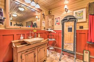 a bathroom with a sink and a mirror at Handcrafted Log Cabin in Candor Group Getaway! in Candor +76 photos