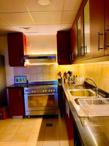 a kitchen with a sink and a stove at York Backpackers - Jumeirah Beach in Dubai