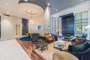 a lobby with couches and chairs and a table at Placemakr Marymount Ballston in Arlington
