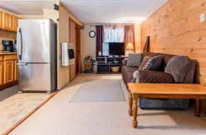 a living room with a couch and a refrigerator at Pocono cabin with private pool at Shawnee Mtn in East Stroudsburg