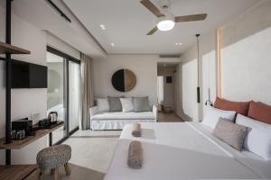 a living room with a couch and a table at Enorme Teatro Beach - Adults Only in Amoudara Herakliou