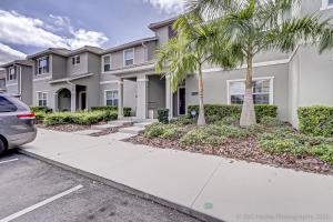 a house with palm trees in front of it at Storey Lake Resort, Private Pool, Near Famous Attractions!! in Kissimmee