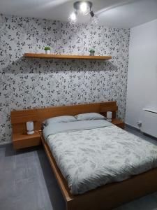 - une chambre avec un lit et une étagère sur le mur dans l'établissement piso acogedor con encanto, à Navas del Rey
