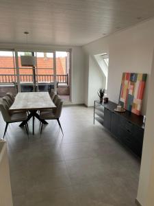 a large living room with a table and chairs at Vakantieverblijf De Munt in Oudenburg