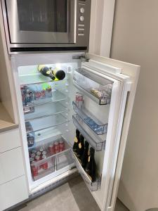 an open refrigerator filled with lots of food and drinks at Vakantieverblijf De Munt in Oudenburg