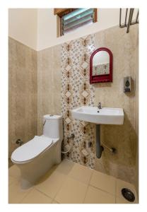 a bathroom with a toilet and a sink at Jaiswal Homestay Pet friendly Entire Bungalow in Jabalpur